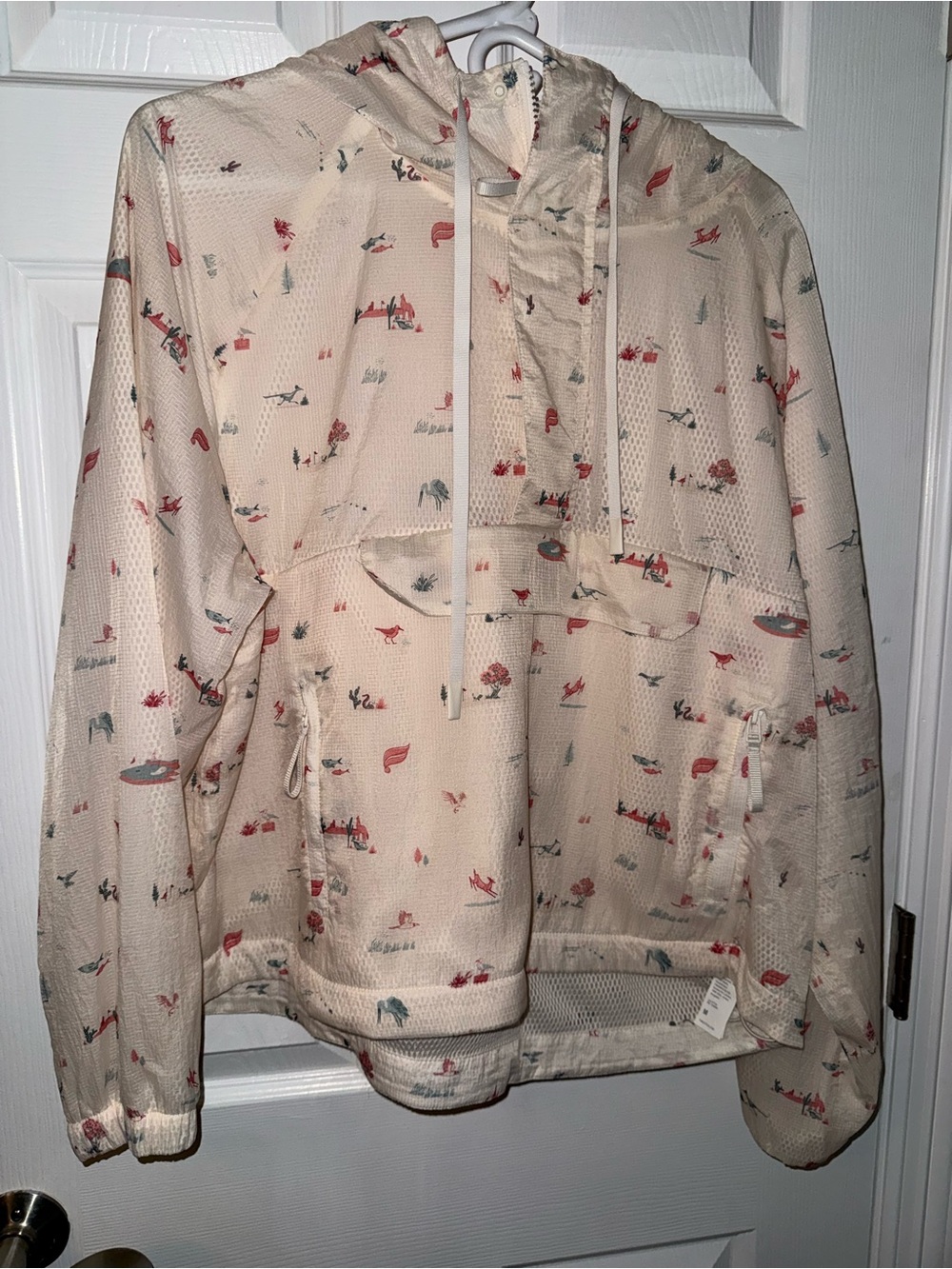 Fabletics Cream Hooded Anorak with Red & Green Print